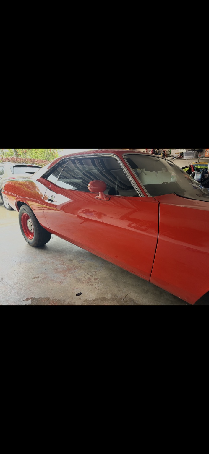 Classic red muscle car with tinted side glass