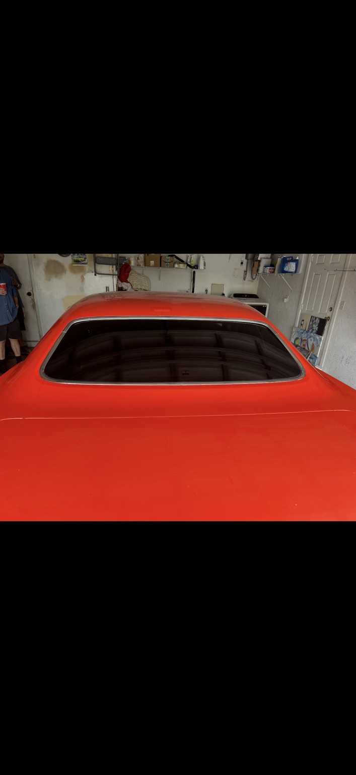 Tinted rear glass on a classic red muscle car
