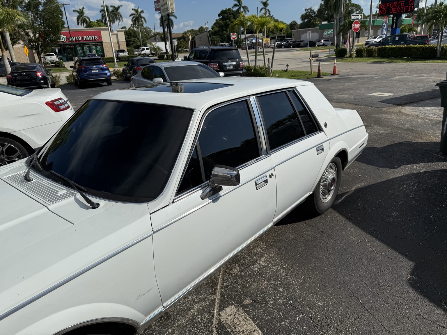 Classic white sedan with dark window tint