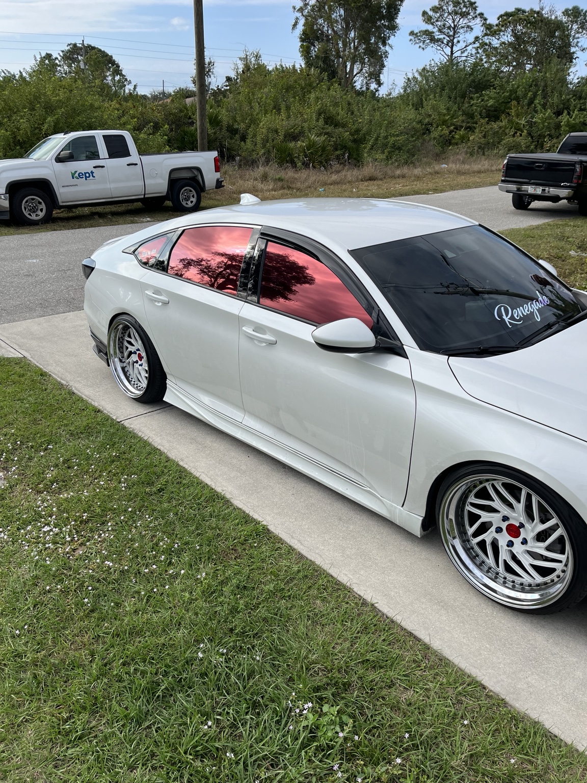 Custom white sedan with dark window tint