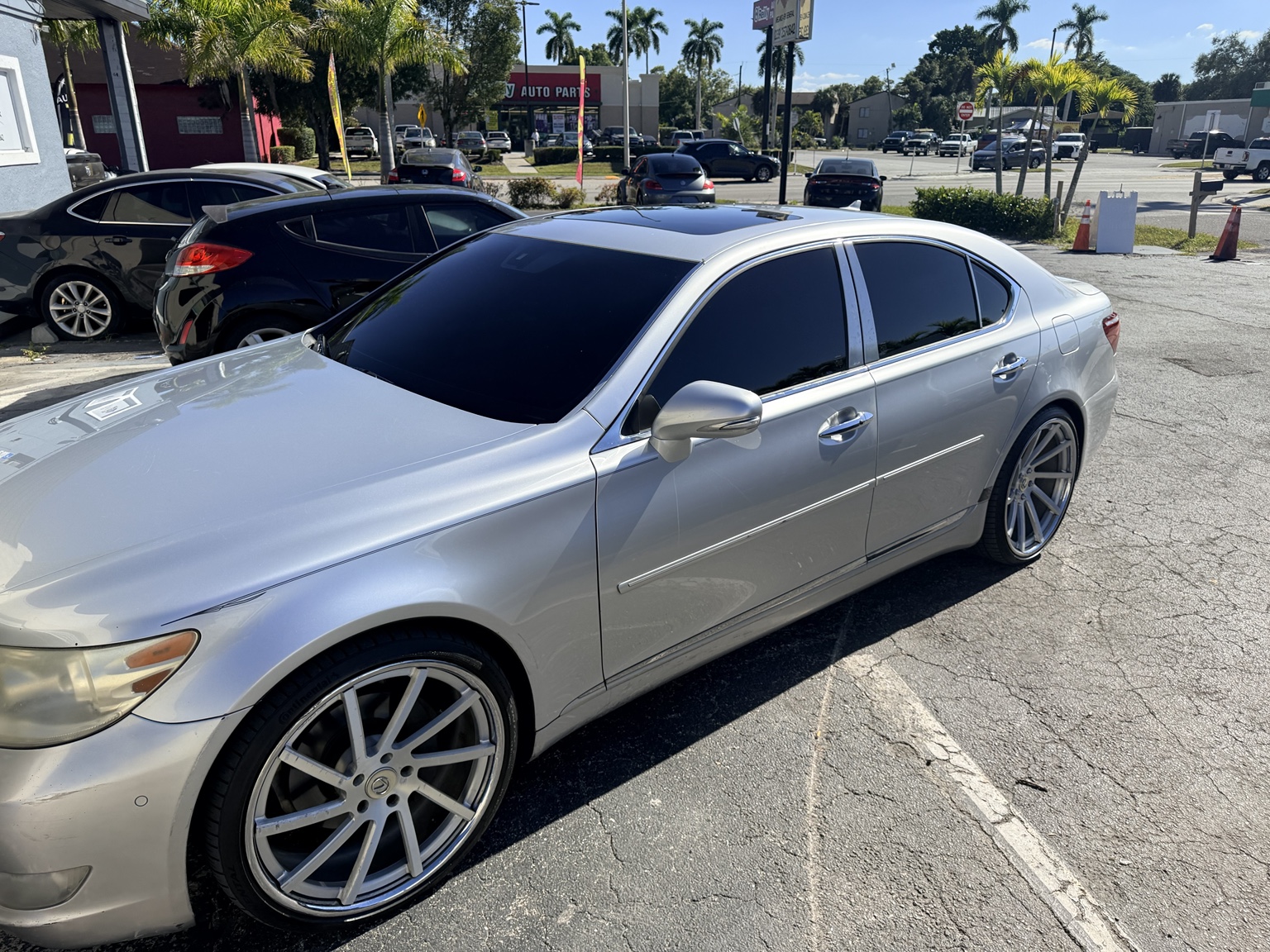 Silver Lexus sedan showing a complete dark window tint