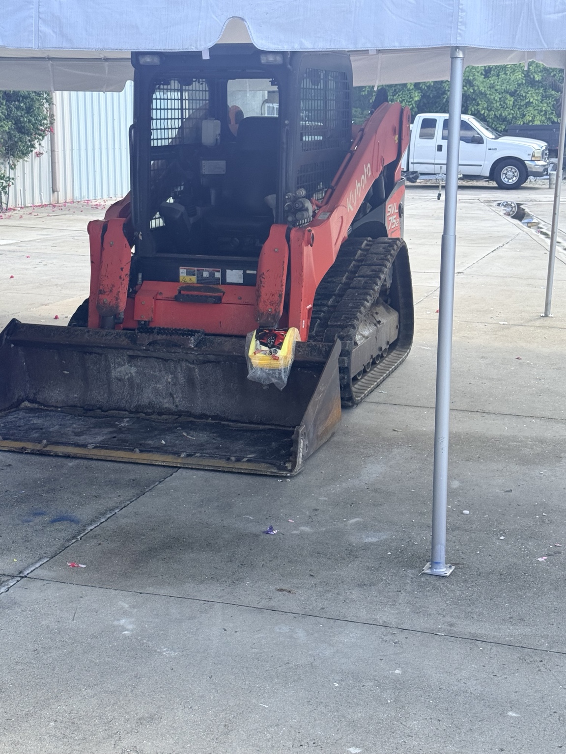 Orange skid steer with tinted cab glass