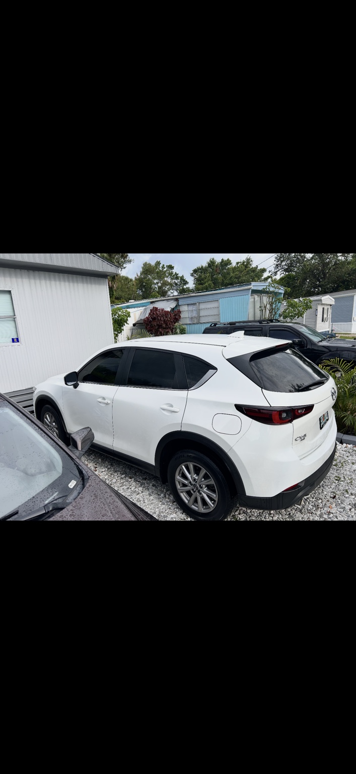 White Mazda SUV with dark window tint
