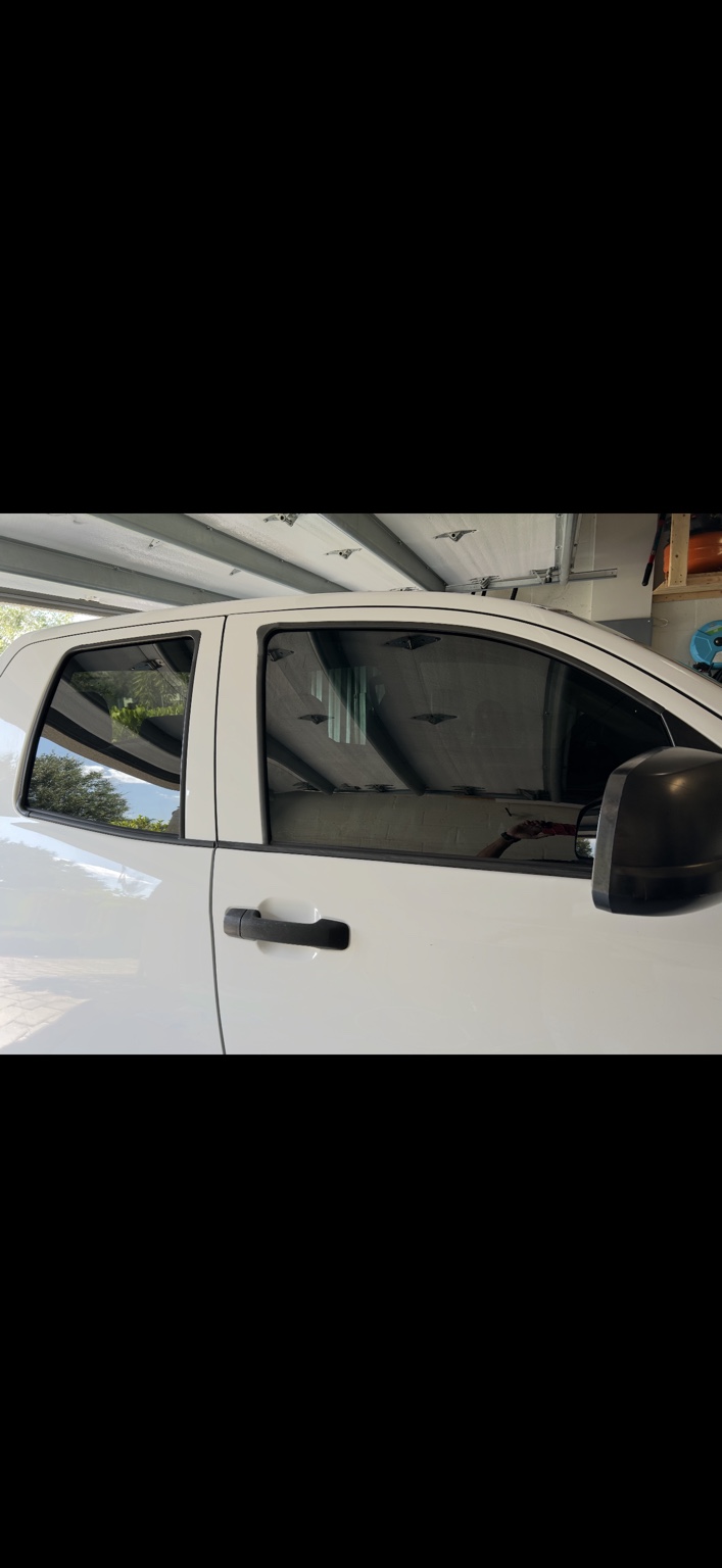 White pickup truck with dark side-window tint