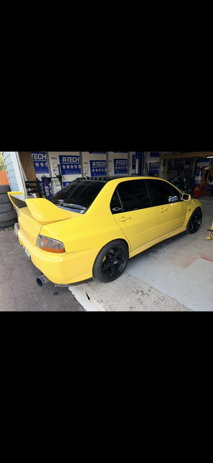 Yellow Mitsubishi with dark window tint